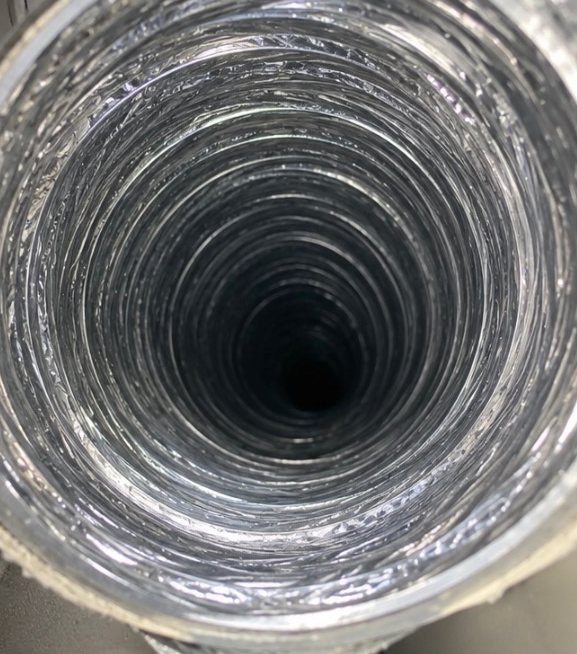 After: the same foil dryer vent duct cleared of lint, open end to end